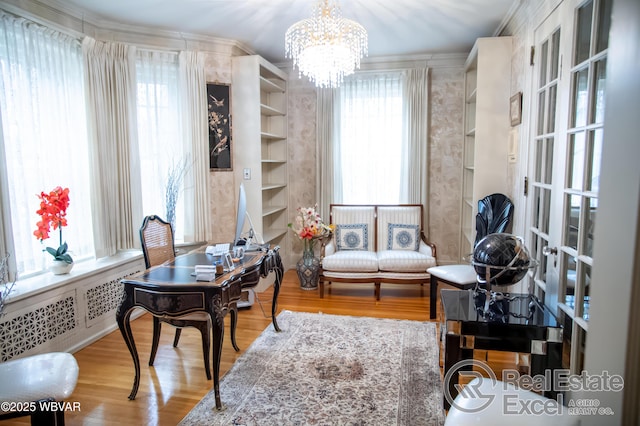 office space with hardwood / wood-style flooring, plenty of natural light, and a notable chandelier