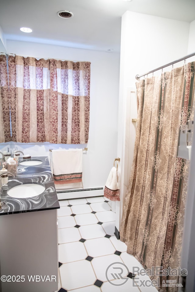 bathroom with vanity and a baseboard radiator