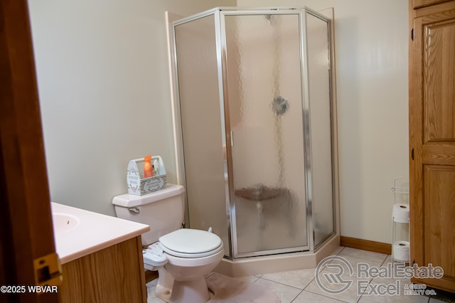 bathroom with an enclosed shower, vanity, tile patterned floors, and toilet