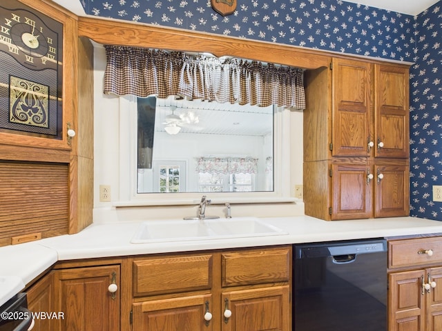 kitchen with black dishwasher, brown cabinets, a sink, and wallpapered walls