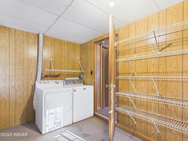 washroom with carpet floors, laundry area, and wooden walls