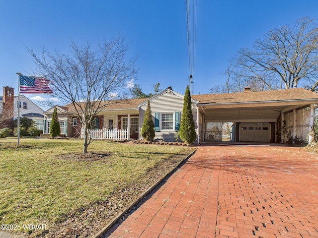 ranch-style house featuring an attached carport, decorative driveway, and a front yard