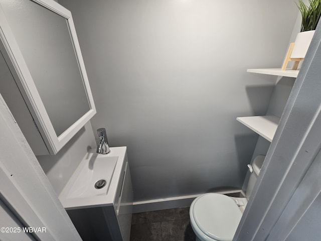 bathroom with vanity, tile patterned floors, and toilet