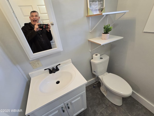 bathroom featuring vanity and toilet