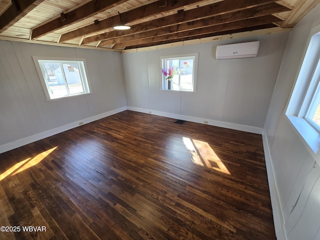 spare room with dark wood-type flooring, a wall mounted AC, wooden ceiling, and beam ceiling