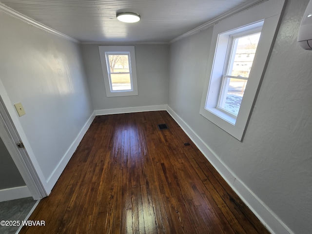 empty room featuring ornamental molding and dark hardwood / wood-style floors