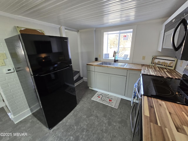 387 Davidson Rd, Jersey Shore, PA 17740 - kitchen featuring black appliances, a sink, brick wall, butcher block counters, and crown molding