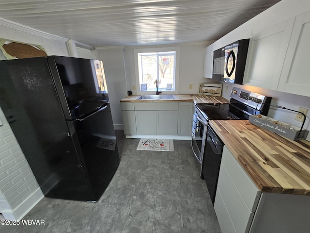 kitchen with sink, white cabinets, wood counters, and black appliances