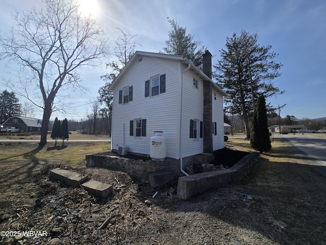 387 Davidson Rd, Jersey Shore, PA 17740 - view of home's exterior featuring dirt driveway, central AC, and a chimney