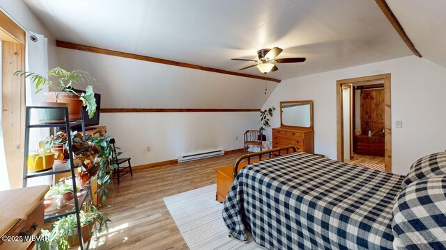 bedroom featuring lofted ceiling, a baseboard radiator, wood finished floors, and baseboards