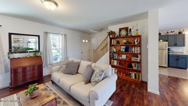 living area with stairway and wood finished floors
