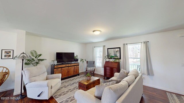 living room with wood finished floors and baseboards