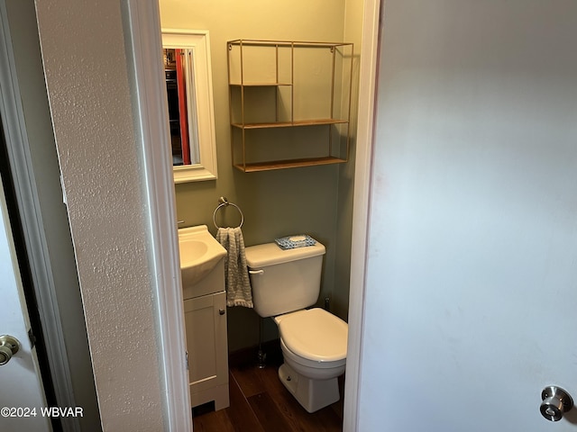 bathroom with vanity, hardwood / wood-style flooring, and toilet