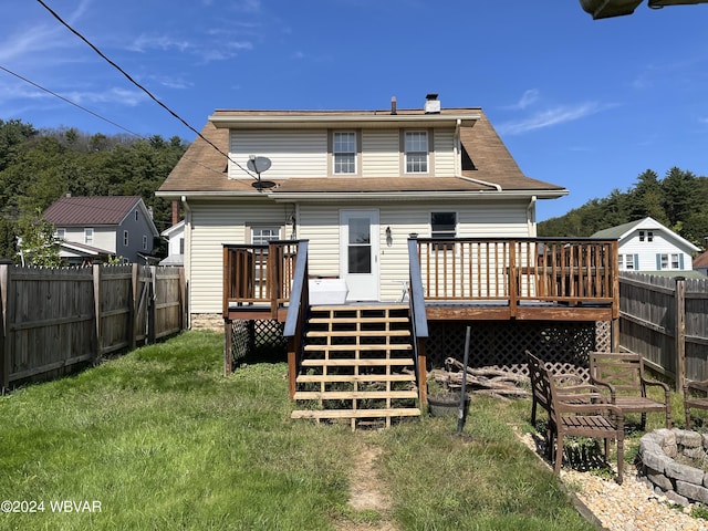 back of house with a lawn and a deck