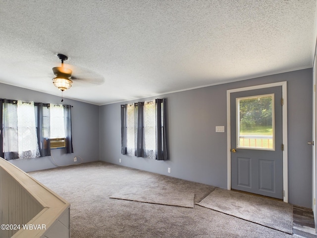 carpeted foyer with ceiling fan, cooling unit, crown molding, and a textured ceiling