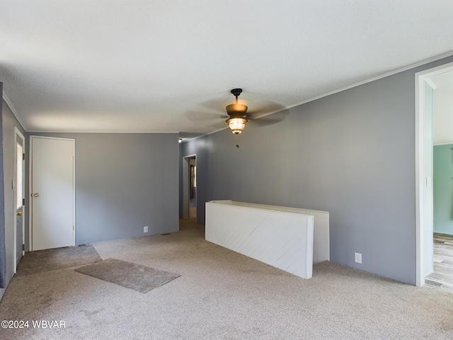 carpeted spare room with ceiling fan