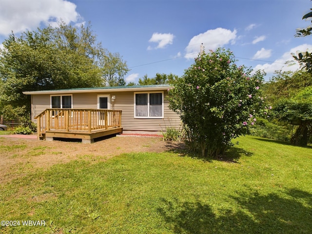 back of house with a yard and a deck