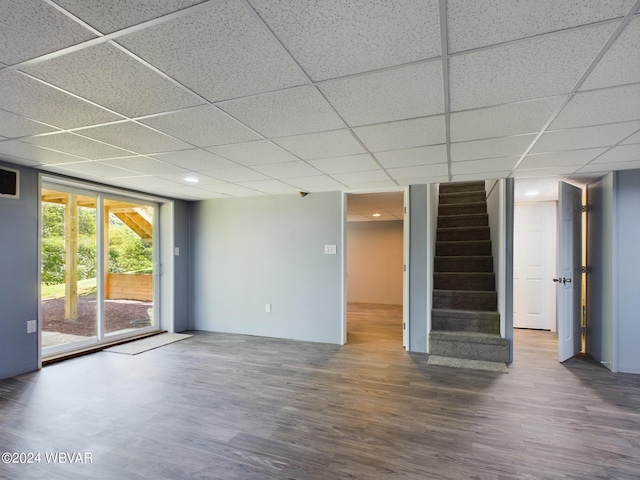 interior space featuring wood-type flooring and a paneled ceiling