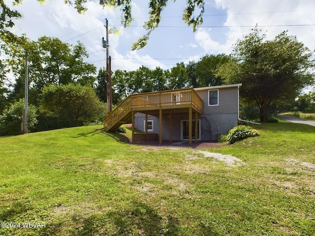 rear view of property featuring a yard and a deck