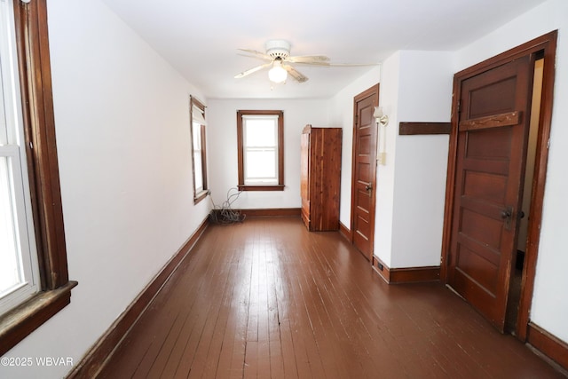 empty room with dark hardwood / wood-style floors and ceiling fan