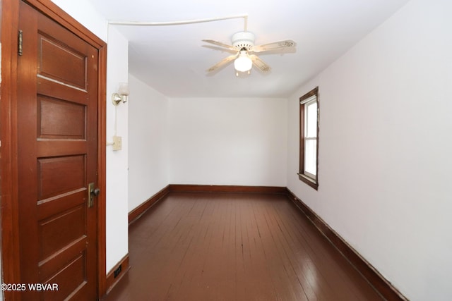 spare room with ceiling fan and dark hardwood / wood-style flooring