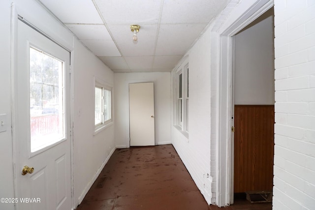 hall featuring a drop ceiling