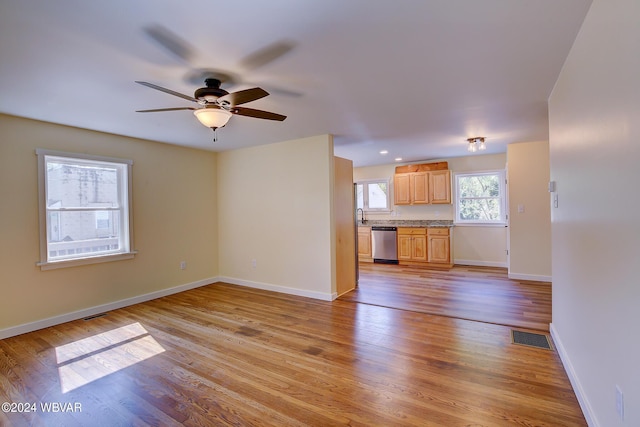 unfurnished living room featuring ceiling fan and light wood-type flooring