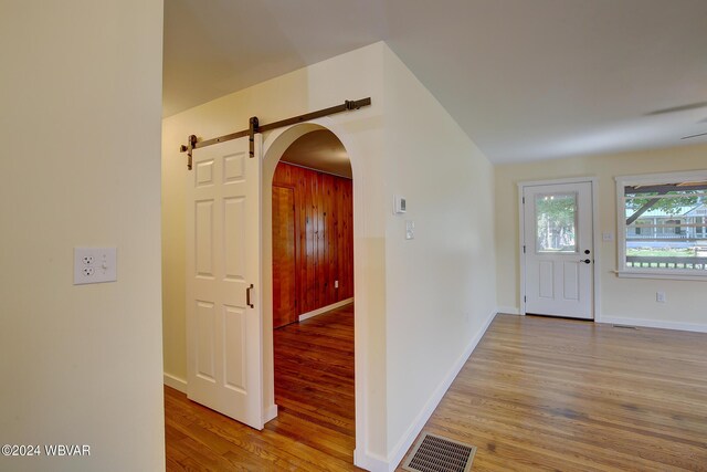 entrance foyer with light hardwood / wood-style floors and a barn door