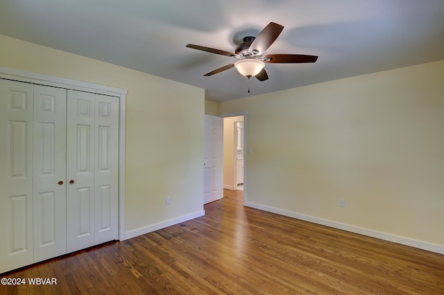 unfurnished bedroom featuring hardwood / wood-style floors, a closet, and ceiling fan