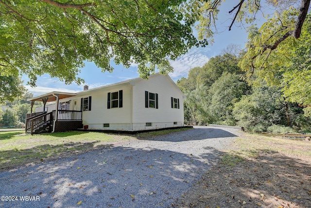 view of side of property featuring covered porch