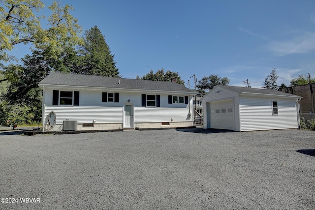 view of front of property featuring an outbuilding, central AC, and a garage