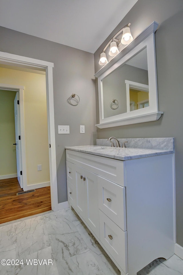 bathroom with hardwood / wood-style flooring and vanity