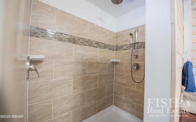 bathroom with a tile shower