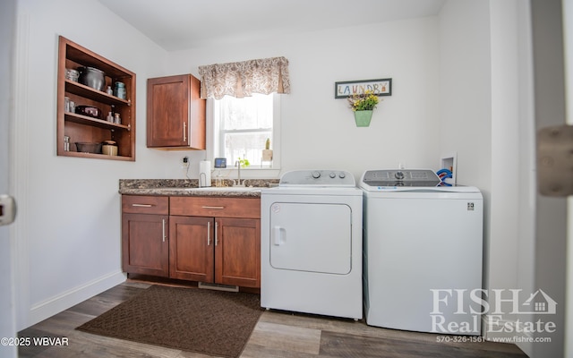 laundry room featuring cabinets, sink, hardwood / wood-style floors, and independent washer and dryer