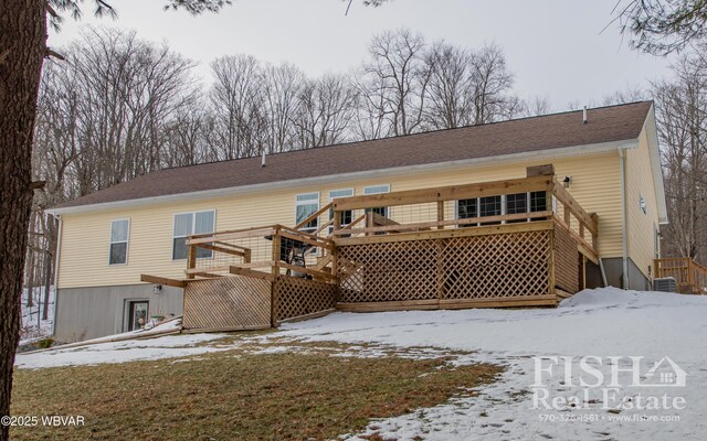 snow covered property featuring a wooden deck