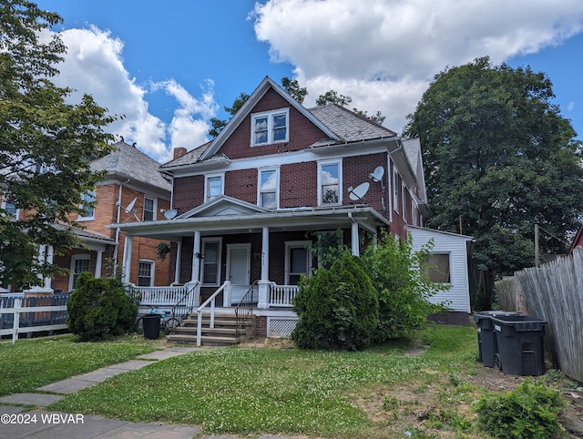 view of front of house featuring a front yard and a porch