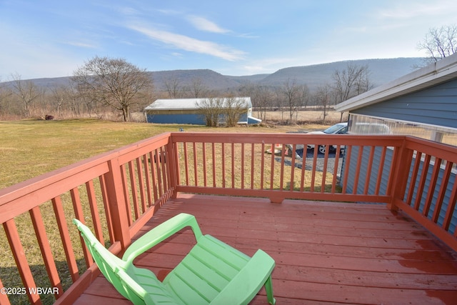 deck featuring a yard and a mountain view