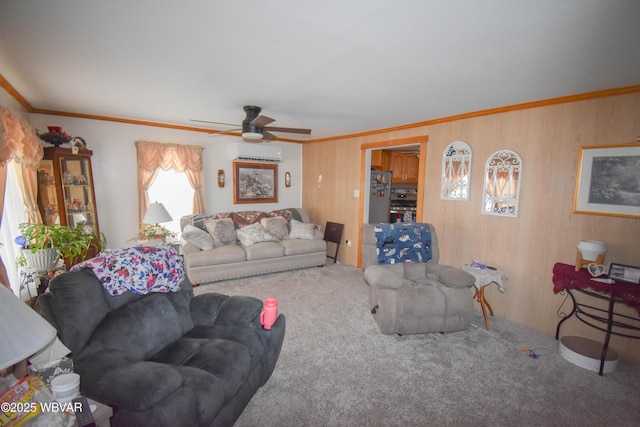 carpeted living area featuring a wall mounted air conditioner, wooden walls, ornamental molding, and a ceiling fan