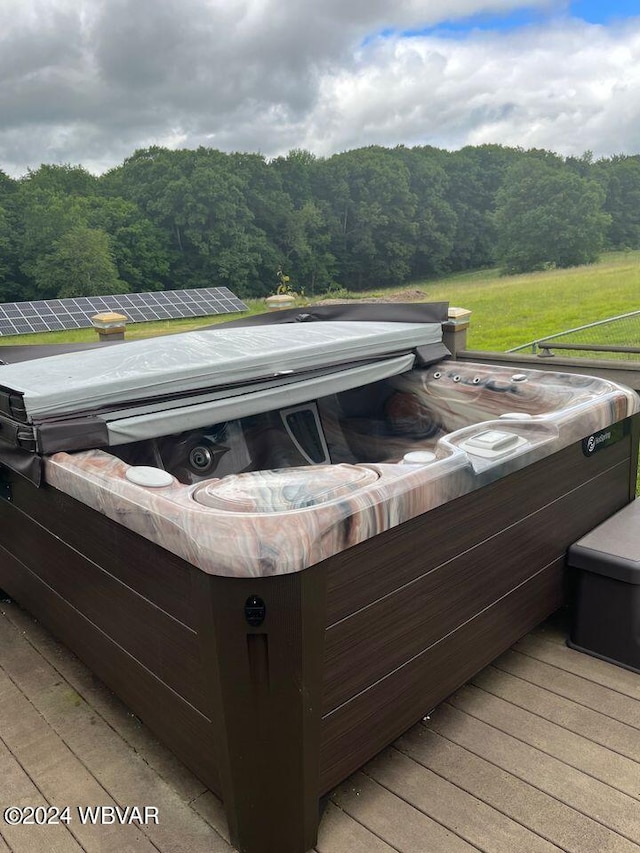 exterior space featuring a deck and a hot tub