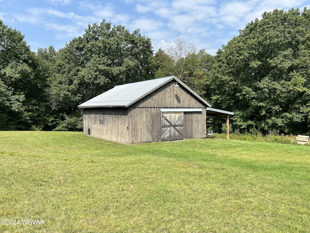 view of outbuilding with a yard