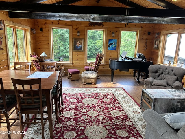 dining area featuring wooden walls, lofted ceiling with beams, hardwood / wood-style flooring, and wooden ceiling