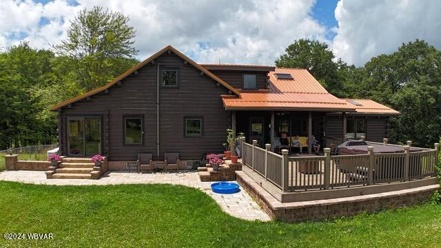 rear view of property with a yard and a patio area