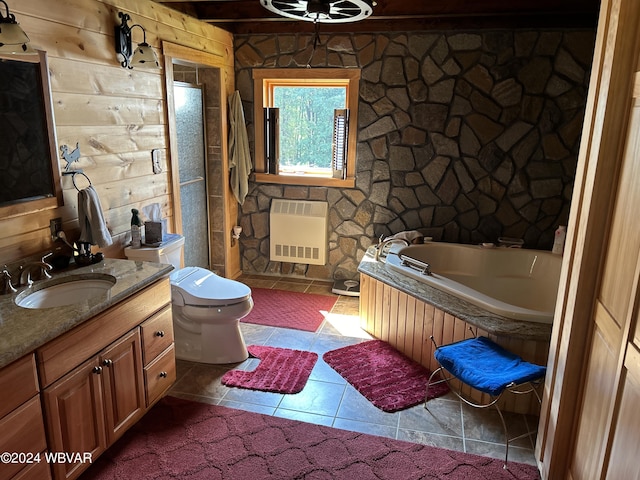 bathroom featuring a bath, tile patterned floors, heating unit, toilet, and vanity