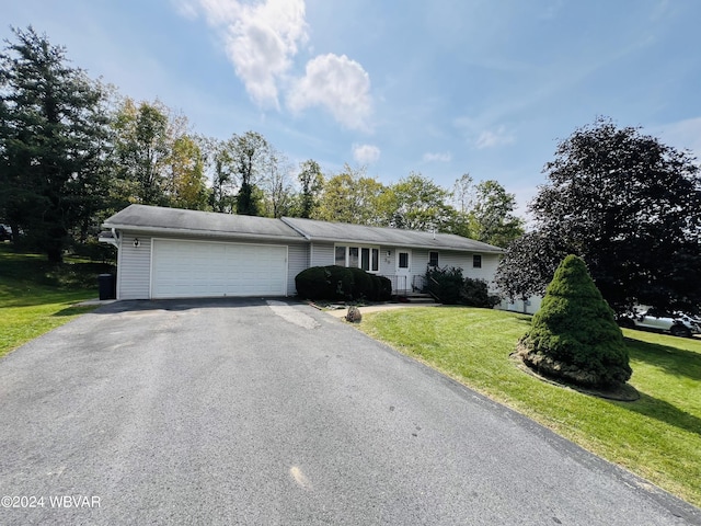 single story home featuring a garage and a front yard