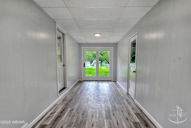 294 Park Ave, Lock Haven, PA 17745 - spare room with wood finished floors, a paneled ceiling, baseboards, and wood walls