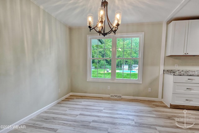 294 Park Ave, Lock Haven, PA 17745 - unfurnished dining area featuring light wood-style floors, ornamental molding, a chandelier, and baseboards