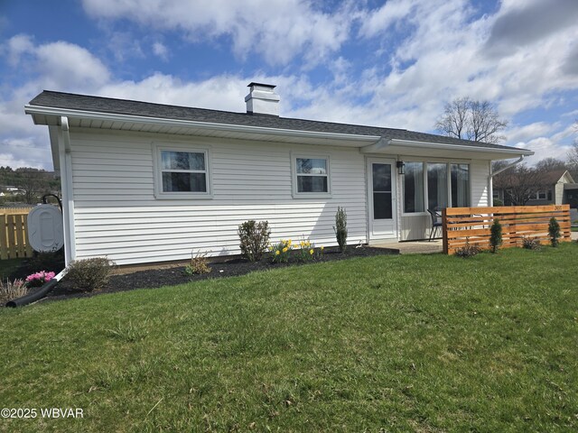 2437 Vista Rd, Williamsport, PA 17701 - back of house featuring a yard, fence, and a chimney