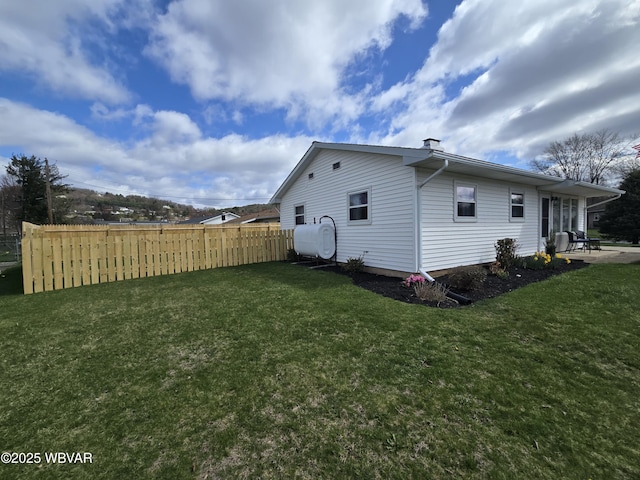 2437 Vista Rd, Williamsport, PA 17701 - view of side of home with a chimney, heating fuel, fence, and a lawn