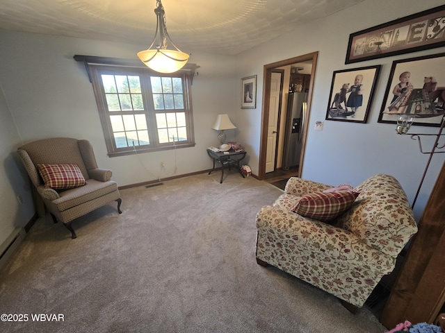 living area featuring carpet flooring and baseboards