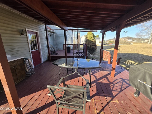 wooden deck with area for grilling and outdoor dining area